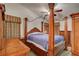 Comfortable main bedroom features wooden furniture, a four-poster bed, and a ceiling fan at 5124 Appealing Ct, Las Vegas, NV 89130