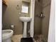 Bathroom features a toilet and pedestal sink and a walk-in shower at 5255 Autumn Sky Rd, Las Vegas, NV 89118