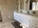 Bathroom features dual sinks, vanity with storage, and tile floors at 5255 Autumn Sky Rd, Las Vegas, NV 89118