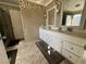 Bathroom features dual sinks, vanity with storage, and tile floors at 5255 Autumn Sky Rd, Las Vegas, NV 89118