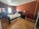 This bedroom features hardwood floors, a large mirror and window, as well as a queen sized bed at 5255 Autumn Sky Rd, Las Vegas, NV 89118