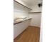Walk-in closet featuring a wooden floor and built-in shelving at 5255 Autumn Sky Rd, Las Vegas, NV 89118