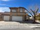 Two story home features a red tile roof, multi car garage, and a low maintenance front yard at 5255 Autumn Sky Rd, Las Vegas, NV 89118