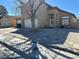 This two-story home has a charming porch and extra wide driveway, leading to the three car garage at 5255 Autumn Sky Rd, Las Vegas, NV 89118