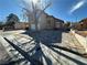 This two-story home has a charming porch and extra wide driveway, leading to the three car garage at 5255 Autumn Sky Rd, Las Vegas, NV 89118