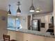 Kitchen features pendant lighting, stainless steel appliances, and a granite breakfast bar at 5255 Autumn Sky Rd, Las Vegas, NV 89118