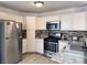 Bright kitchen has stainless appliances including a gas range, microwave, and a refrigerator at 5255 Autumn Sky Rd, Las Vegas, NV 89118