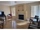 The sun filled living room features a decorative fireplace and tile flooring at 5255 Autumn Sky Rd, Las Vegas, NV 89118
