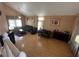 Open floor plan living room with wood-look floors and recessed lighting is great for entertaining at 5255 Autumn Sky Rd, Las Vegas, NV 89118