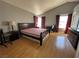 Spacious bedroom featuring wood floors, a large bed, and a window at 5255 Autumn Sky Rd, Las Vegas, NV 89118