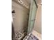 Shower with glass door, shelves, and decorative mosaic tile at 5255 Autumn Sky Rd, Las Vegas, NV 89118
