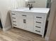 Bathroom vanity with white countertop, black hardware, and ample storage space at 555 E Silverado Ranch Blvd # 1034, Las Vegas, NV 89183