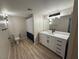 Modern bathroom featuring a vanity with black fixtures and a combination shower and tub at 555 E Silverado Ranch Blvd # 1034, Las Vegas, NV 89183