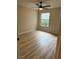 Bright bedroom with modern ceiling fan, wood floors, and natural light from the window at 555 E Silverado Ranch Blvd # 1034, Las Vegas, NV 89183
