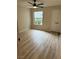 Bedroom with wood-look flooring, a window, and closet doors at 555 E Silverado Ranch Blvd # 1034, Las Vegas, NV 89183