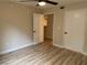 This bedroom features a ceiling fan, wood floors, and access to a closet and bathroom at 555 E Silverado Ranch Blvd # 1034, Las Vegas, NV 89183