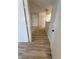 Bright hallway featuring wood-look floors leading to a white front door at 555 E Silverado Ranch Blvd # 1034, Las Vegas, NV 89183
