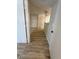Bright hallway featuring wood-look floors leading to a white front door at 555 E Silverado Ranch Blvd # 1034, Las Vegas, NV 89183