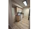 Bright kitchen with white appliances, wood cabinets, and wood-look flooring at 555 E Silverado Ranch Blvd # 1034, Las Vegas, NV 89183