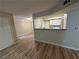 Open floor plan featuring a kitchen with breakfast bar and white appliances at 555 E Silverado Ranch Blvd # 1034, Las Vegas, NV 89183