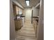 Galley kitchen with white appliances and wood-look flooring at 555 E Silverado Ranch Blvd # 1034, Las Vegas, NV 89183