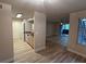 Open-concept living space with wood-look floors and integrated kitchen and laundry area at 555 E Silverado Ranch Blvd # 1034, Las Vegas, NV 89183