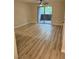 Bright living room with light wood floors and sliding glass door at 555 E Silverado Ranch Blvd # 1034, Las Vegas, NV 89183