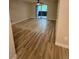 Bright living room with wood-look flooring, ceiling fan, and balcony access at 555 E Silverado Ranch Blvd # 1034, Las Vegas, NV 89183