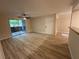 Living room with wood-look flooring, ceiling fan, and sliding glass doors to patio at 555 E Silverado Ranch Blvd # 1034, Las Vegas, NV 89183