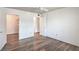 A bright bedroom features a ceiling fan, light wood floors, and access to a walk-in closet at 5710 E Tropicana Ave # 1017, Las Vegas, NV 89122