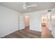 Bright bedroom features a ceiling fan, light wood floors, and access to a walk-in closet and bathroom at 5710 E Tropicana Ave # 1017, Las Vegas, NV 89122