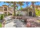 A common area with mature shade trees, walkway, a bench, and a community mail kiosk at 5710 E Tropicana Ave # 1017, Las Vegas, NV 89122