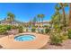 A community spa surrounded by palm trees and lush landscaping near residential buildings at 5710 E Tropicana Ave # 1017, Las Vegas, NV 89122