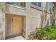 Ground floor unit with screen door, beige exterior and colorful landscaping at 5710 E Tropicana Ave # 1017, Las Vegas, NV 89122