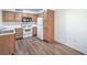 Bright kitchen features white appliances, and wood cabinets, and vinyl wood flooring at 5710 E Tropicana Ave # 1017, Las Vegas, NV 89122