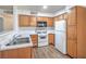 The kitchen features wood cabinets, white counters and appliances, with lots of storage space at 5710 E Tropicana Ave # 1017, Las Vegas, NV 89122
