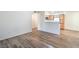 View of the Living Room with updated wood flooring leading to the kitchen in neutral, modern colors at 5710 E Tropicana Ave # 1017, Las Vegas, NV 89122