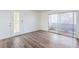 Spacious living room area features vinyl wood flooring and sliding glass door to a covered outdoor patio at 5710 E Tropicana Ave # 1017, Las Vegas, NV 89122