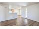 Open-concept living area with wood flooring, white walls and easy access to the kitchen at 5710 E Tropicana Ave # 1017, Las Vegas, NV 89122