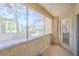 A covered patio with a view of lush greenery, seating, and a peek at the neighborhood at 5710 E Tropicana Ave # 1017, Las Vegas, NV 89122