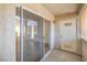 A covered patio featuring a sliding glass door leading inside and an exterior door for access at 5710 E Tropicana Ave # 1017, Las Vegas, NV 89122