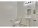 Powder room with pedestal sink, oval mirror, and tiled floor at 5713 Silver Cascade Ave, Las Vegas, NV 89131