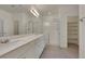 Bright bathroom features double sinks, granite countertops, and a glass-enclosed shower at 5713 Silver Cascade Ave, Las Vegas, NV 89131