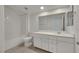 Well-lit bathroom features a shower/tub combo, tile floors, and a vanity with white cabinets and a quartz countertop at 5713 Silver Cascade Ave, Las Vegas, NV 89131