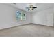 Bright bedroom with carpet, a window with blinds, and a white door at 5713 Silver Cascade Ave, Las Vegas, NV 89131