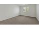 Neutral bedroom with carpet flooring and large window at 5713 Silver Cascade Ave, Las Vegas, NV 89131