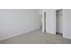 Bedroom features neutral carpet, white walls, base molding and a large closet with sliding doors at 5713 Silver Cascade Ave, Las Vegas, NV 89131