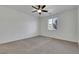 Neutral bedroom featuring carpet, a ceiling fan, and a view from the window at 5713 Silver Cascade Ave, Las Vegas, NV 89131