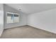 Bedroom features neutral carpet, white walls, base molding and a window with blinds at 5713 Silver Cascade Ave, Las Vegas, NV 89131
