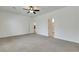 Spacious bedroom featuring neutral carpet, ceiling fan, and ensuite bathroom access at 5713 Silver Cascade Ave, Las Vegas, NV 89131